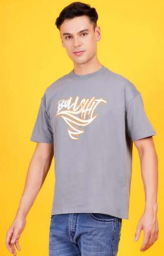 Young man wearing a stylish gray t-shirt with bold graphic design on a bright yellow background.