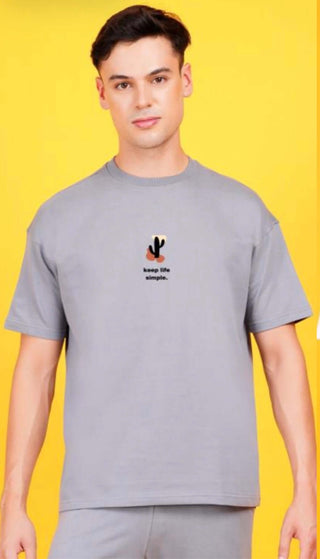 Model wearing a gray Terry Drop Shoulder T-Shirt Printed with cactus design for a casual look.